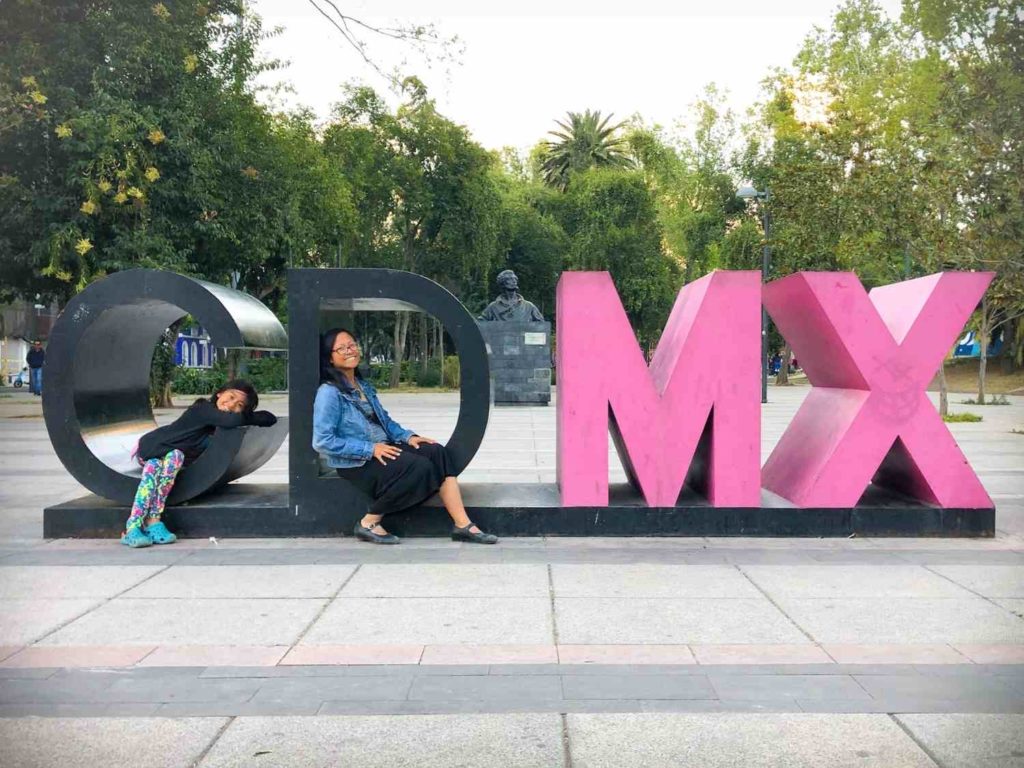 A girl and a woman enjoying a Mexico family vacation in the CDMX sign in Mexico City, Mexico