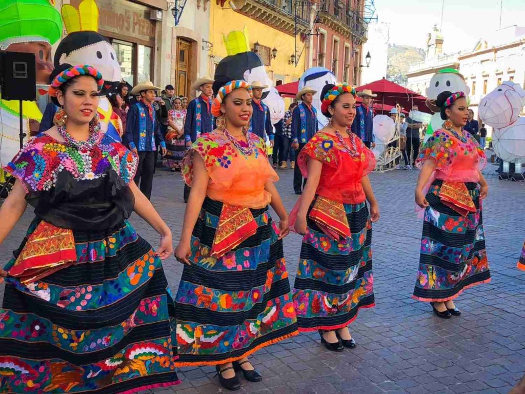 Dancers in traditional Mexican performing on a street